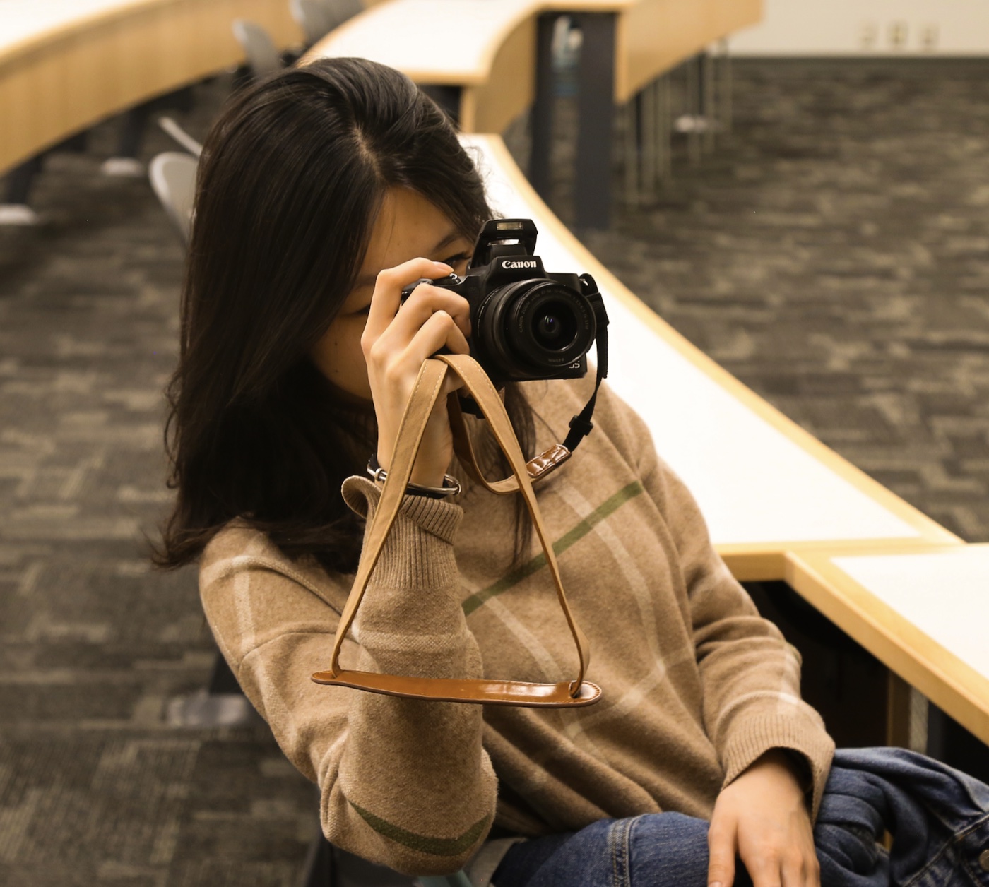 Mary Li taking a photograph with a camera